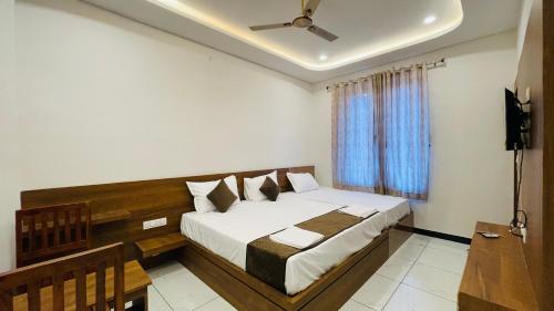 a bedroom with a large bed and a window at Hotel Pushkar Town in Pushkar