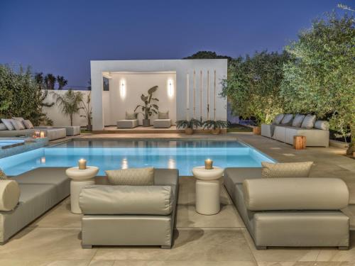 a villa with a swimming pool at night at The White Luxury Villa - Private Seaview Villa with Pool by Villa Mana Gers in Vasilikos