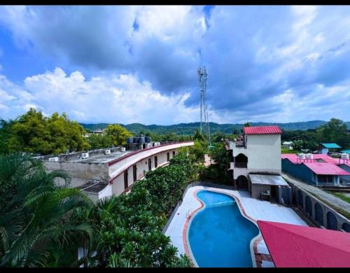 arial view of a resort with a swimming pool at Staybook The Rudveda Resort - Free High Tea near Pool Area in Rāmnagar