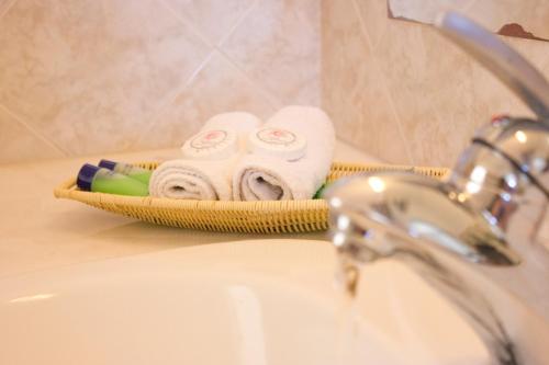 a bathroom sink with towels and a faucet at Anixi - Primavera Mykonos in Ornos