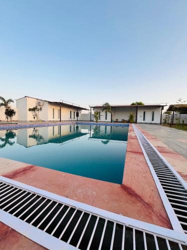 a swimming pool in the middle of a building at GR Outhouse in Jaipur