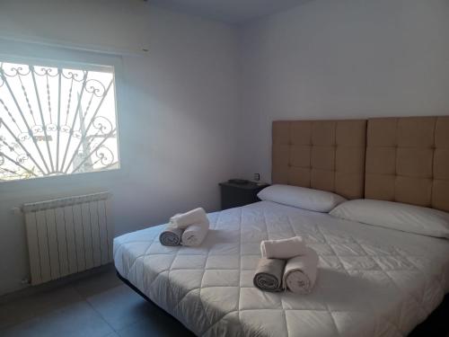 a bedroom with a bed with two towels on it at Villa Can Goldi con vistas al mar in Sant Josep