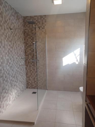 a shower with a glass door in a bathroom at Villa Can Goldi con vistas al mar in Sant Josep