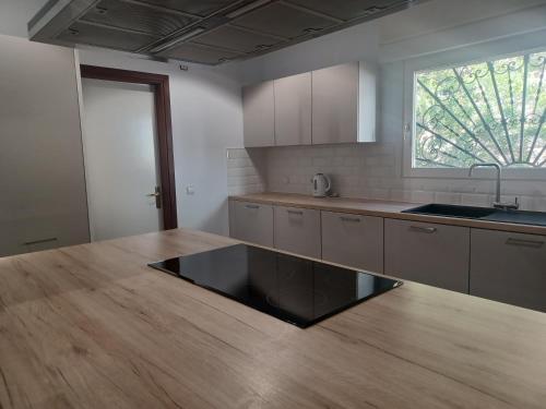 a kitchen with a wooden counter top and a window at Villa Can Goldi con vistas al mar in Sant Josep