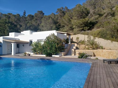 a villa with a swimming pool and a house at Villa Can Goldi con vistas al mar in Sant Josep