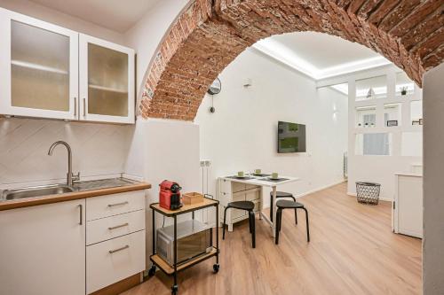 a kitchen with a sink and a table with chairs at Mascardi29 in Sarzana