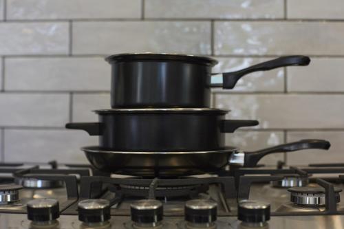 a large black pot sitting on a stove at Hayy Luxury Retreat At The Lodge in Bradford