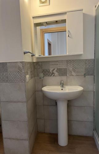 a bathroom with a sink and a mirror at b & b Jasmine in Santa Teresa di Riva