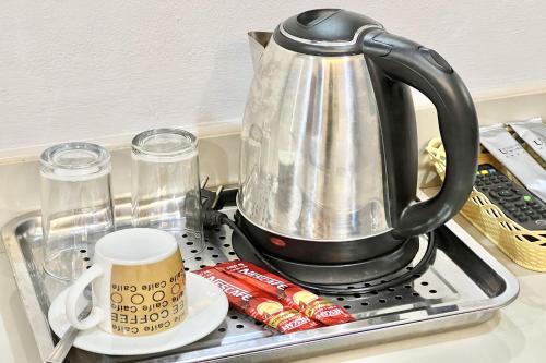 a tea kettle sitting on top of a stove at Full House Udon in Ban Bo Nam