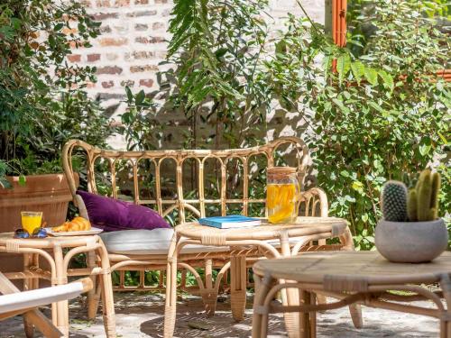 a patio with two chairs and a table and a bench at ibis Styles Paris Nation Cours de Vincennes in Paris