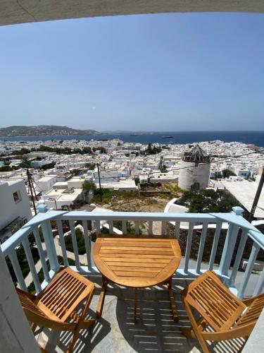 a couple of chairs and a table on a balcony at THE VIEW OF MYKONOS in Mýkonos City