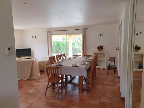a large dining room with a long table and chairs at Gîte des Falaises 10 à 12 personnes in Souspierre