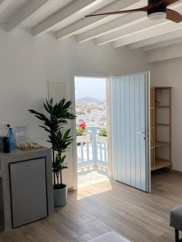 a living room with a door open to a balcony at THE VIEW OF MYKONOS in Mýkonos City