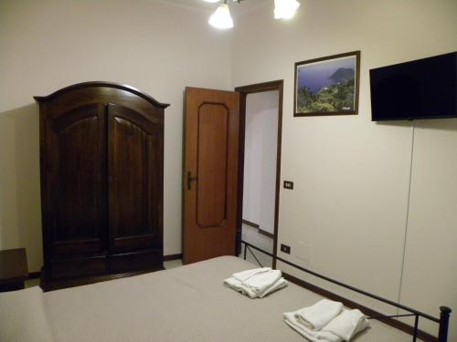 a bedroom with a bed with two towels on it at Case Vacanze Albamarina in Lipari