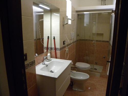 a bathroom with a sink and a toilet and a mirror at Case Vacanze Albamarina in Lipari