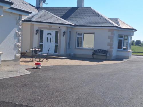 a small house with a bench in front of it at Ballnamona house in Cong