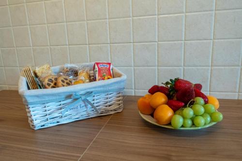 a basket of food and a bowl of fruit on a counter at The Regin in Civitavecchia