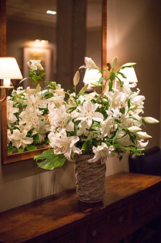 a vase filled with white flowers on a table at Monbijou Hotel in Berlin