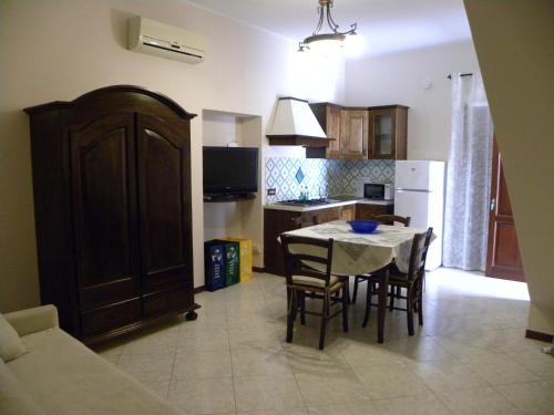 a kitchen with a table and chairs in a room at Case Vacanze Albamarina in Lipari