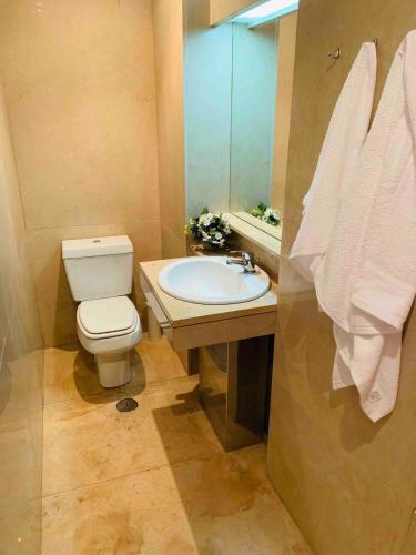 a bathroom with a toilet and a sink and a mirror at Póvoa TOP - Beachfront in Póvoa de Varzim