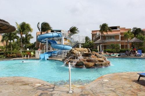 a water slide in a pool in a resort at Divi Studio in Palm-Eagle Beach