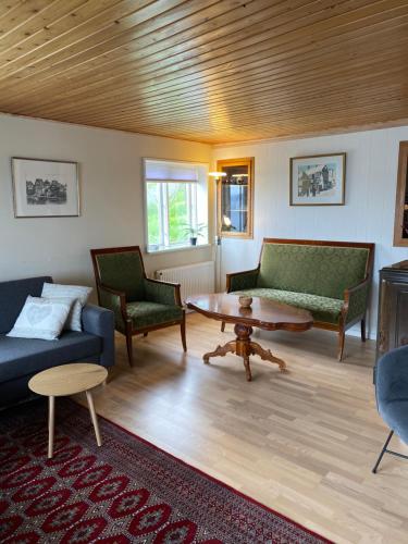 a living room with two couches and a coffee table at 2BR Home with Sea Views and Parking - Tórshavn in Tórshavn