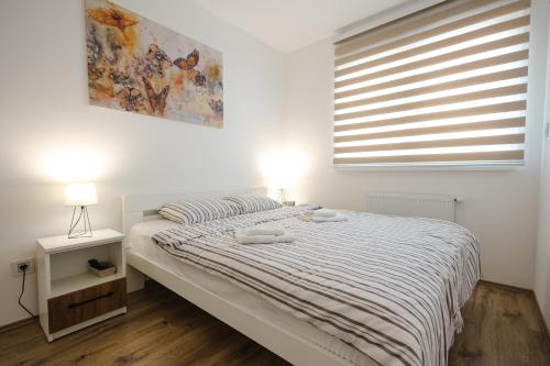 a bedroom with a bed with two towels on it at Apartman Anika Banja Koviljača in Banja Koviljača