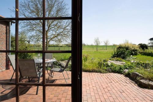 a view from a window of a patio with a table and chair at Ferienhaus May App 1 in Sahrensdorf