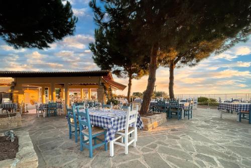 a restaurant with blue and white tables and chairs at 4 bedroom Villa Helidoni with private infinity pool, Aphrodite Hills Resort in Kouklia