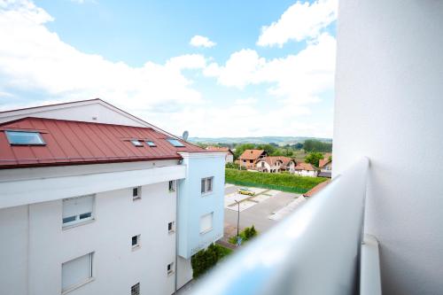 a view from the balcony of a building with a red roof at Apartman Anika Banja Koviljača in Banja Koviljača