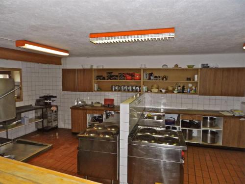 a large kitchen with lots of stainless steel appliances at Maison St-Pierre in Bourg-Saint-Pierre