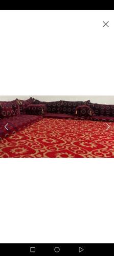 an image of a room with a red carpet at The black jewel Umm Al Jamal in Jurf ad Darāwīsh