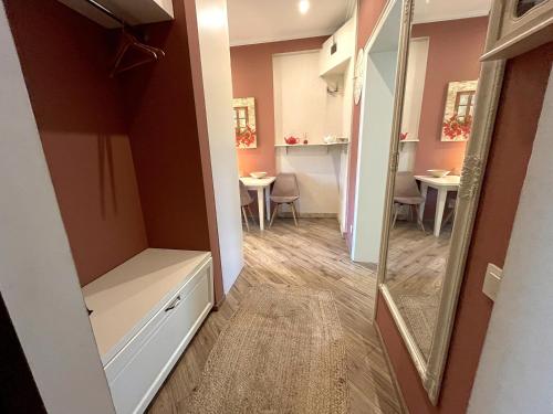 a room with a mirror and a hallway with tables at Villa Nelma in Ventspils