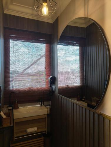a bathroom with a mirror and a sink at Shalom Suites in Kota Kinabalu
