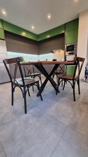 a dining table and two chairs in a kitchen at Vila Kladenci in Radožda