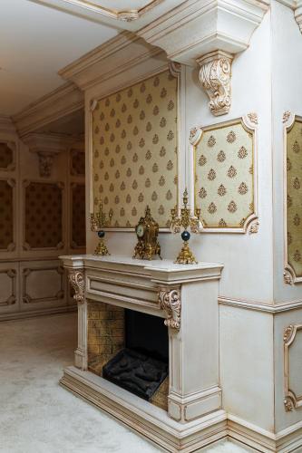 an ornate fireplace in a room with a wall at Ayan Palace Hotel in Tovuz