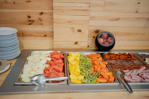 a tray filled with different types of food on a table at Naranjos Resort Menorca in S'Algar