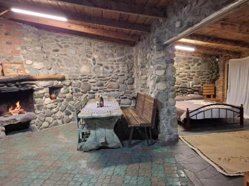 a stone room with a table and a fireplace at Safari House Tbilisi Wine & Family Hotel in Tbilisi City