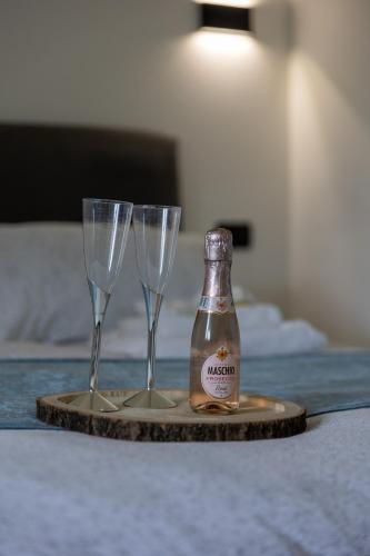 two champagne glasses and a bottle on a table at HI15 Apartment - Garage Privato in Como