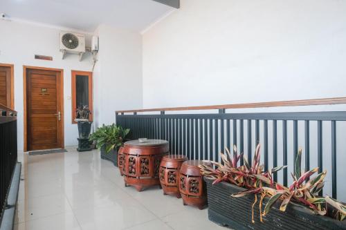 a room with three drums sitting next to a fence at RedDoorz @ Jalan Kedawung in Malang