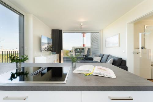 a living room with a table with books on it at Beltblick in Marienleuchte