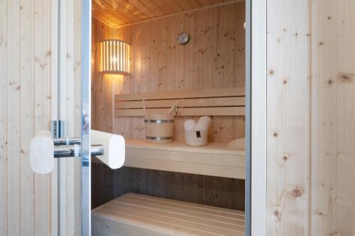 a bathroom with wooden walls and a counter with a sink at Beltblick in Marienleuchte