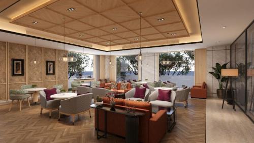 a living room with couches and tables and chairs at Vivanta Thane LBS Road in Thane