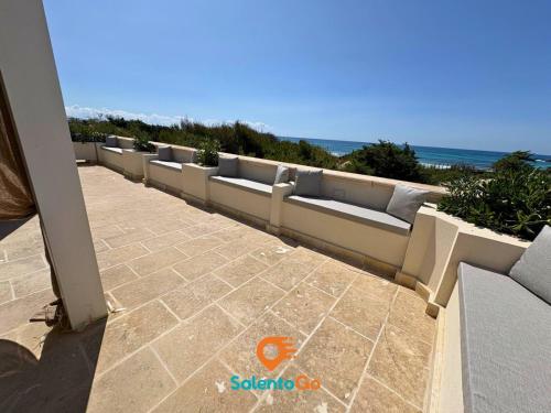 a row of couches sitting on top of a patio at Stanze VILLA DEL CONTE a Punta Prosciutto by SalentoGo in Punta Prosciutto
