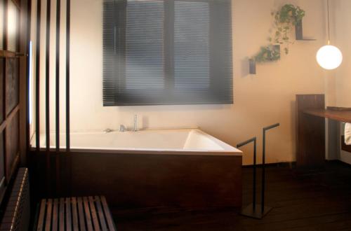 a bath tub in a bathroom with a window at Casa Boumort in Sant Marti de Canals
