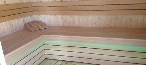 a sauna with a bench in the middle at Pensjonat Kwiatkowski apartament nr 4 in Nowęcin