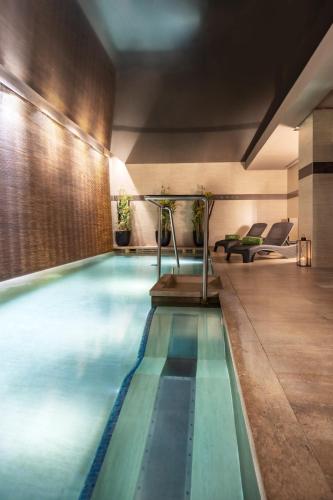 a large swimming pool in a hotel room at Meliá Genova in Genova