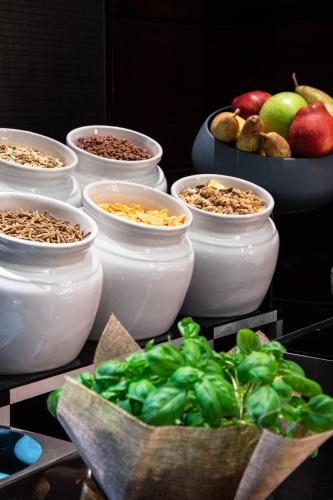 a group of bowls of food with fruits and vegetables at Meliá Genova in Genova