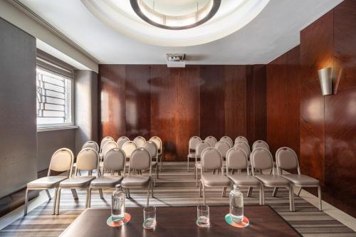 a row of chairs in a room with a round ceiling at Meliá Genova in Genova