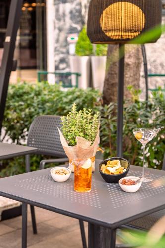 a table with a drink and bowls of food on it at Meliá Genova in Genova